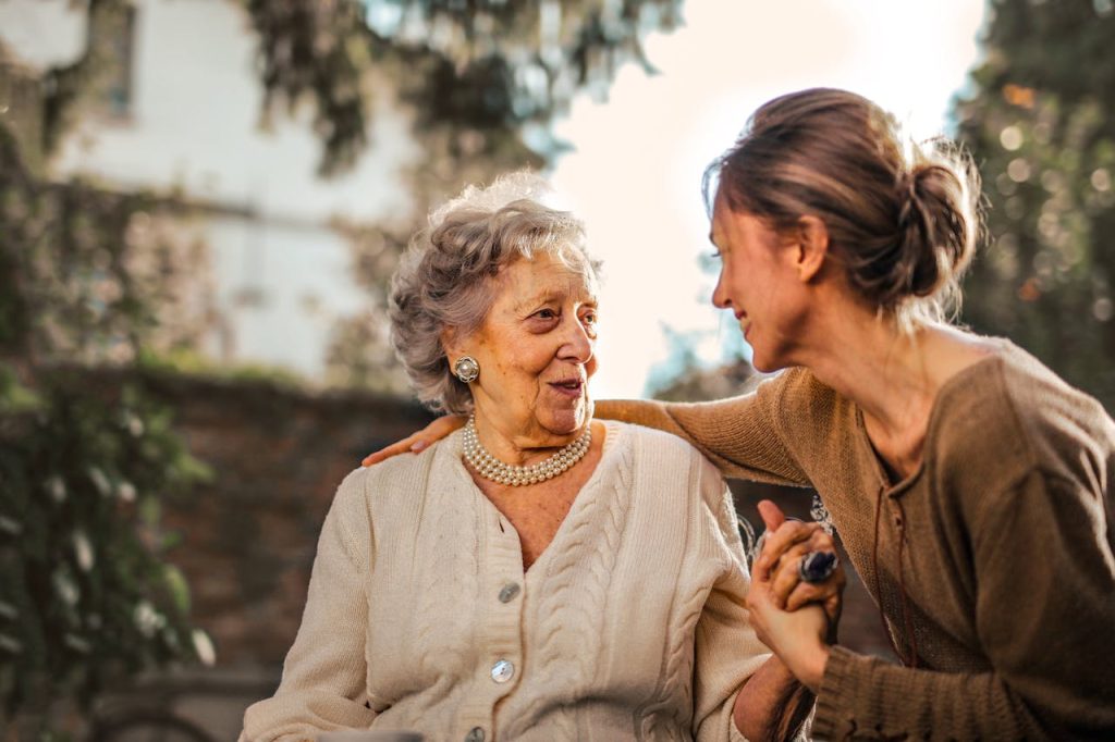joyful-adult-daughter-greeting-happy-surprised-senior-mother-in-garden-3768131 Elderly woman and adult daughter share a joyful, affectionate moment in a sunny garden.